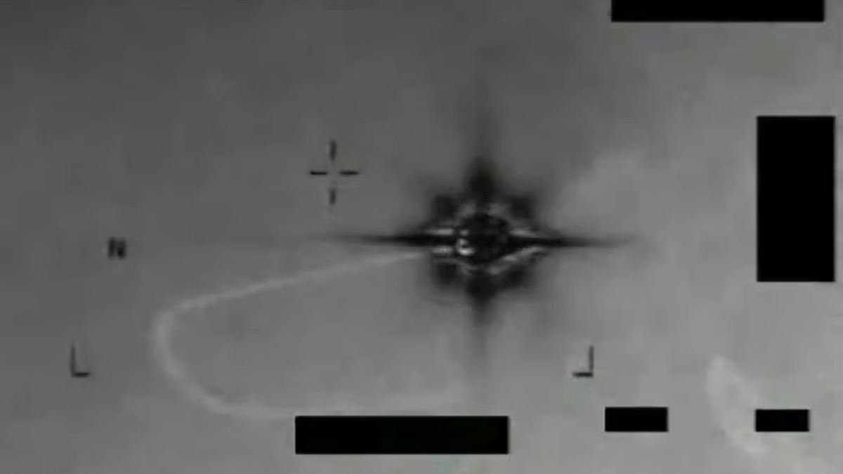 A grayscale infrared image shows a star-shaped contrast pattern surrounded by tracking marks and blacked-out areas.