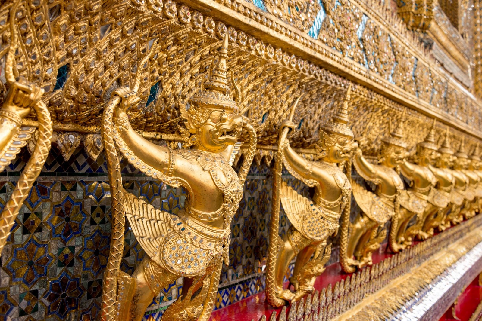 Golden Garuda figures with outstretched wings at Wat Phra Kaew.