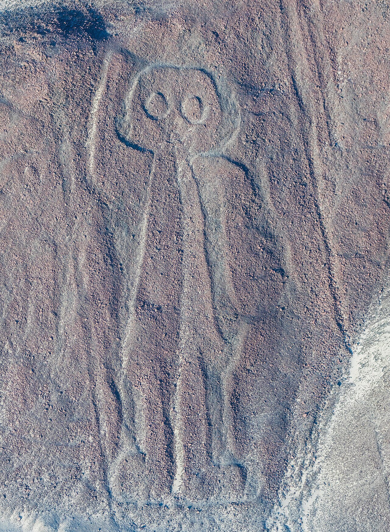 A large humanlike geoglyph appears on a hillside in the Nazca region.